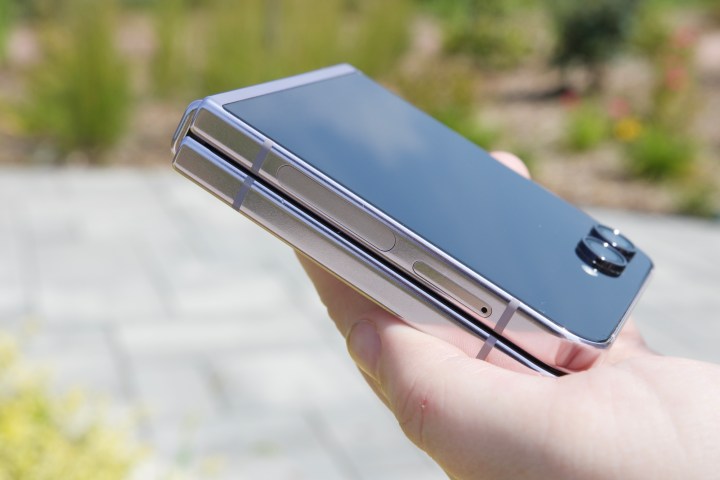 某人拿着合上的 Galaxy Z Flip 5，展示手机合上时如何完全折叠平放。